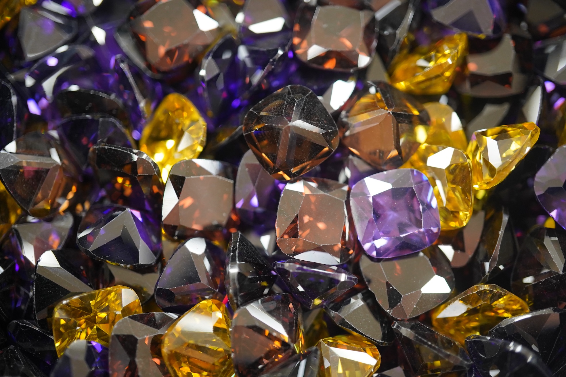 A quantity of assorted cut coloured cubic zirconia stones. Condition - poor to fair to good